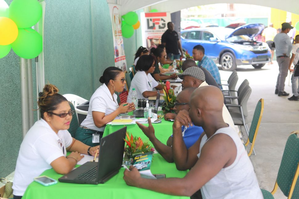 Citizens Bank loan officers attending to persons enquiring about the bank’s ‘Borrow Smart Buy Smart’ promotion, which was launched yesterday. (Terrence Thompson photo)
