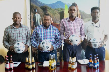Members of the launch party for the 4th Annual Corona Beer Futsal Championship at Top Brandz Distributors headquarters yesterday. From left to right are, Petra Organisation member Sean Embrack, Petra Co-Director Troy Mendonca, Corona Brand Manager Colin Stuart, and Petra Organisation member Mark Alleyne.
