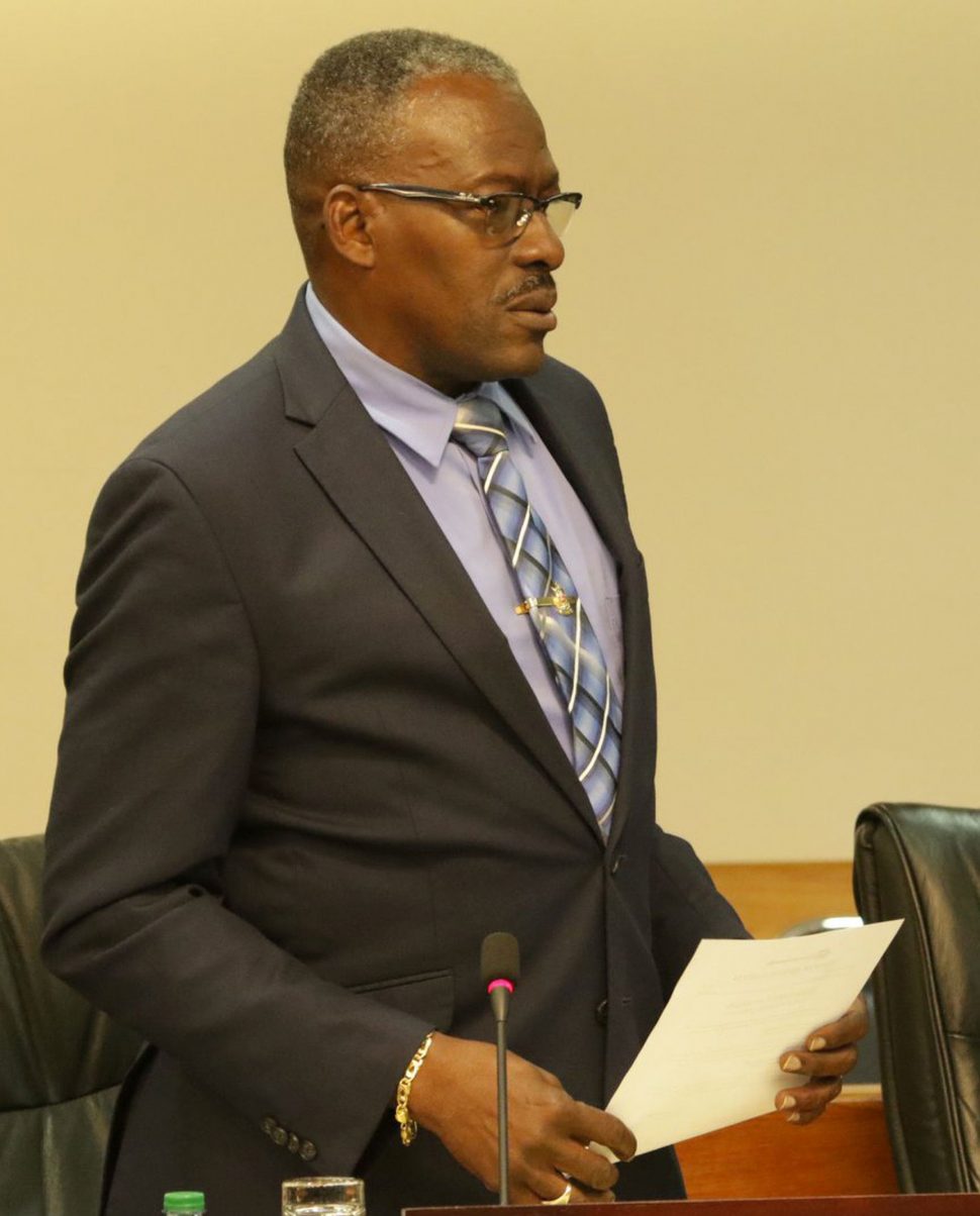 Minister of Housing and Urban Development Edmond Dillon responds to a question on behalf of the Minister of National Security during yesterday’s sitting of Parliament.
