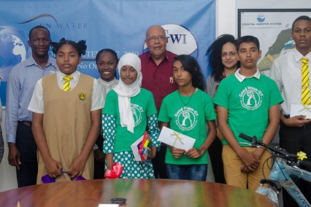 The winners of the competitions pose for a photo with GWI’s Managing Director, Dr Richard Van West-Charles (centre) and the judges. (GWI photo)