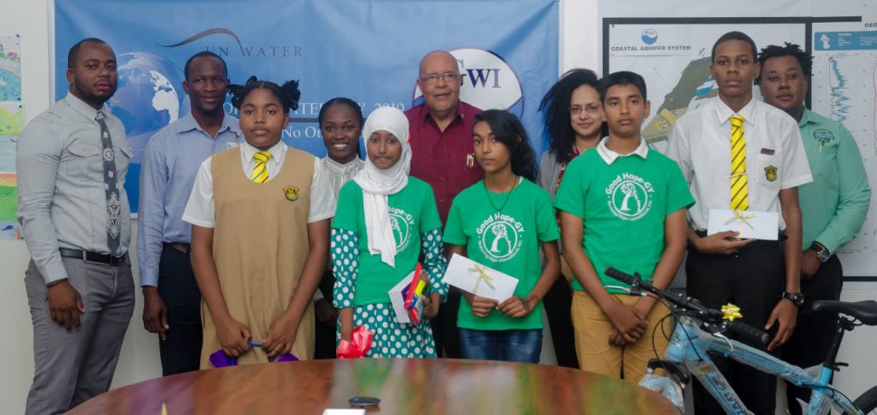 The winners of the competitions pose for a photo with GWI’s Managing Director, Dr Richard Van West-Charles (centre) and the judges. (GWI photo)