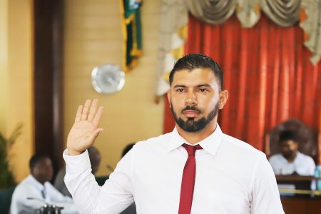 Dwayne Adams of the Peoples Pro-gressive Party/Civic takes the oath of a councilor of the City of Georgetown. 