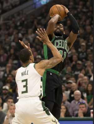 Boston Celtics guard Kyrie Irving shoots over Milwaukee Bucks guard George Hill yesterday during the opening Eastern Conference semi-final round. (Reuters photo)