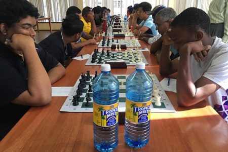Taffin Khan (left) and Anthony Drayton clashed last Sunday in the qualifier for the National Chess Championship. The game was drawn. Khan emerged winner of the competition and Drayton placed second. Khan and Loris Nathoo were the two persons to play unbeaten throughout the competition. At the 2018 Chess Olympiad in Georgia, Khan and Drayton played Guyana’s top chess boards. (Photo: Irshad Mohammed) 
