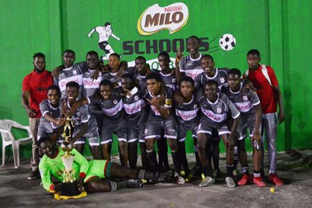The victorious Christianburg/Wismar unit of Linden posing with the coveted Milo Secondary School Football Championship after defeating Lodge Secondary 1-0 at the Ministry of Education ground.
