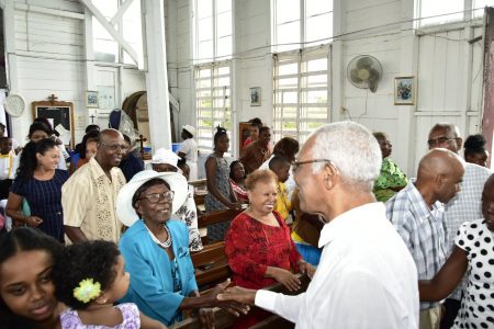 President David Granger greets an elderly member of the St Matthew’s Parish Church congregation.
