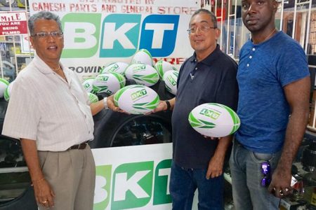 Roop Persaud, CEO of Ganesh Parts and General Store presented balls to the President of the Guyana Rugby Football Union (GRFU), Peter Green yesterday as PRO of the union, Esan Griffith looks on.