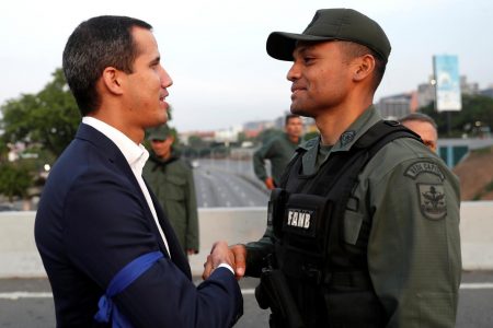 Venezuela's Guaido (left) says troops have joined him to end Maduro presidency - Reuters
