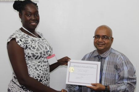 Deputy Permanent Secretary, Ministry of Social Protection, Adrian Ramrattan presents one of the participants with her certificate of participation