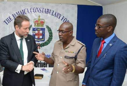 Chris Hind (left), general manager, JN General Insurance Comany, talks road safety with Trevor Christie, deputy superintendent, National Police College Faculty of Operations Management and Skill Training, and driver upgrading course graduate officer Ryan Reddie. 