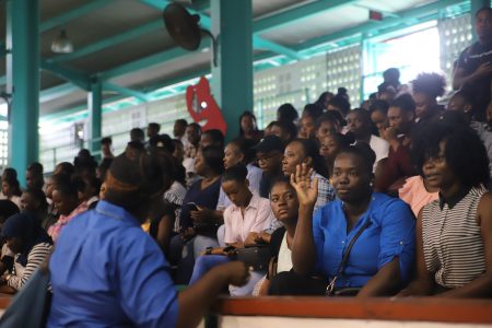 Youths waiting to be interviewed by companies present at the job fair held at the Cliff Anderson Sports Hall yesterday. (Terrence Thompson photo)