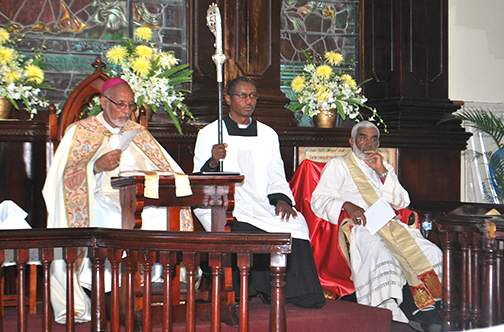 Lord Bishop Howard Gregory (left) is assisted by Canon Michael Allen (centre) and Bishop of Kingston Robert Thompson at the opening service of their 149th Synod at the Parish Church of St James. 