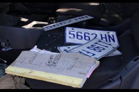 Two sets of licence plates and a book on the seats of the Nissan AD Wagon in which the three cops were travelling when they were intercepted by an off-duty policeman.