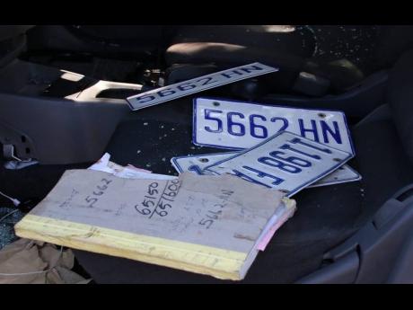 Two sets of licence plates and a book on the seats of the Nissan AD Wagon in which the three cops were travelling when they were intercepted by an off-duty policeman.