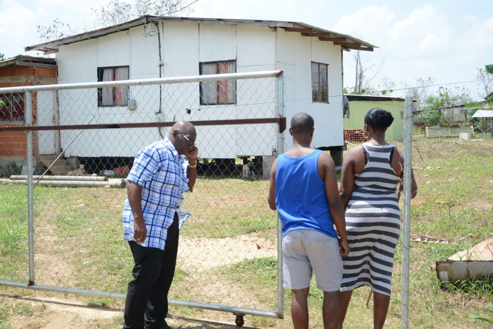 Relatives of murder victim Terry Elie return to his home yesterday where he was attacked on Saturday night.