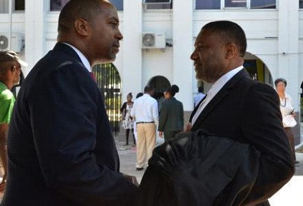 People’s National Party (PNP) General Secretary Julian Robinson (left) converses with Phillip Paulwell outside the Supreme Court, downtown Kingston yesterday following the ruling by the Constitutional Court.