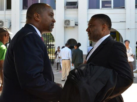 People’s National Party (PNP) General Secretary Julian Robinson (left) converses with Phillip Paulwell outside the Supreme Court, downtown Kingston yesterday following the ruling by the Constitutional Court.