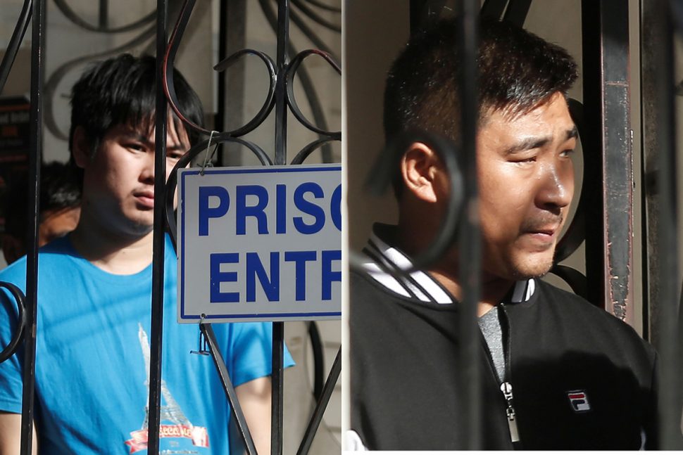 Chinese national Wei Liang Wu (left) and Jan Boa Wang (right) leaves the Port-of-Spain Magistrates’ Court, yesterday.