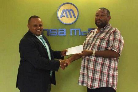 Ansa McAl CEO Troy Cadogan (left) hands over the sponsorship to BCB President Hilbert Foster.
