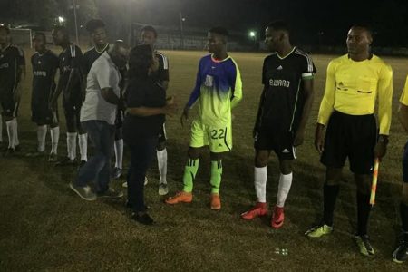 Dismissed Former Head of GFF Referees Stanley Lancaster [right] standing in light during the pageantries as Linden mayor Waneka Arrindell meets the players ahead of the Amelia’s Ward and Capital FC clash
