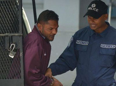 Keshan Bajnathsingh (left), on his way to court. Photo: Dexter Philip