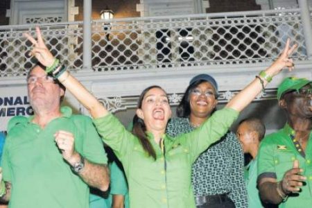 Jamaica Labour Party candidate Ann-Marie Vaz greets supporters celebrating her victory in the Portland Eastern parliamentary by-election last night at a meeting in Port Antonio square. On stage with her are her husband Daryl, the Member of Parliament (MP) for Portland Western, and Juliet Holness, wife of Prime Minister Andrew Holness and MP for St Andrew East Rural. (Photo: Joseph Wellington) 
