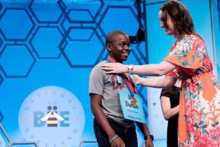 Eleven-year-old Jamaican speller Darian Douglas of Glenmuir High School is awarded his medal after being named among the finalists in the 2019 Scripps National Spelling Bee yesterday. There are 565 spellers in this year’s competition, ranging in age from seven to 15. The finals will take place today.