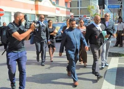 Corruption-accused Gerald Ramdeen (centre) on his way to court on Monday 