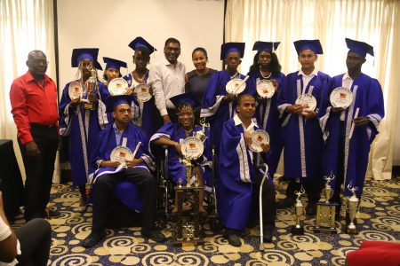 The graduating students along with Manager of the Open Doors Centre, Arthur Lewis (left) and Chief Medical Officer Dr Shamdeo Persaud (standing fifth from left).
