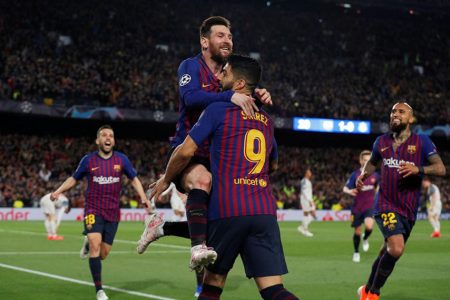 Barcelona’s Lionel Messi celebrates scoring their second goal with Luis Suarez and team mates against Liverpool on Wednesday. (Reuters/Albert Gea)