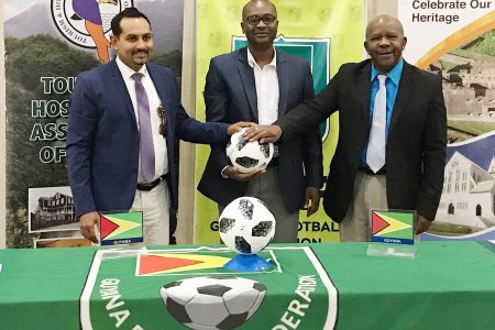 THAG President Mitra Ramkumar (left), GFF President Wayne Forde (centre) and Department of Tourism Director General Donald Sinclair pose for the cameras following the launch ceremony for the FIFA development conference.