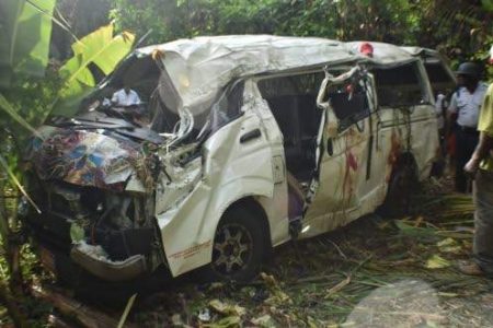Blood stains are seen on the wrecked remains of this minibus that plunged 70 metres into a ravine in Portland yesterday, killing a Titchfield High School student. Twenty-three other students from Titchfield and Port Antonio High, as well as the driver and conductor, were injured in the crash and have been hospitalised. (Photo: Everard Owen) 