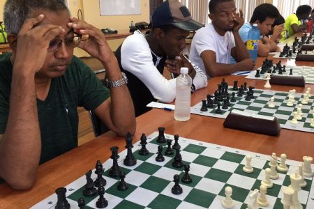 Loris Nathoo (left) in action at a recent tournament. He prepared and delivered the 2019 chess calendar to the Guyana Chess Federation. Nathoo supported the idea of Essequibo, Linden and Berbice entering the National Championships following hosting of their regional tournaments. He is adamant the game should be expanded to include each region. For the moment, however, players from Essequibo, Linden and Berbice should be given incentives to participate in the National Championships. 