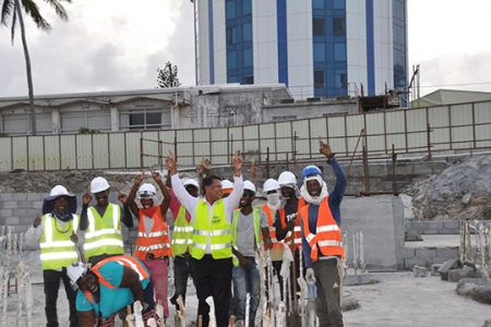 Robert Badal (centre) with Guyanese workers on the site.
