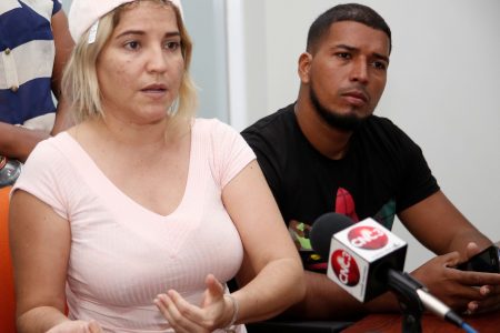 Venezuelan national Jhaymie Zoque, left, speaks to reporters at GML Building, St Vincent Street, Port-of-Spain, yesterday on behalf of relatives of missing boat passengers from La Guaira, Venezuela, who went missing on a trip to Trinidad last Thursday. At right is Jose Mata whose relative is one of the missing passengers.