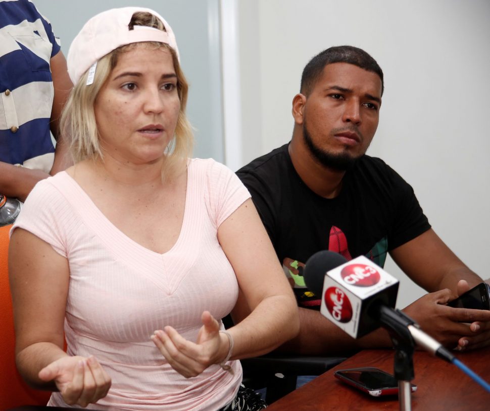 Venezuelan national Jhaymie Zoque, left, speaks to reporters at GML Building, St Vincent Street, Port-of-Spain, yesterday on behalf of relatives of missing boat passengers from La Guaira, Venezuela, who went missing on a trip to Trinidad last Thursday. At right is Jose Mata whose relative is one of the missing passengers.