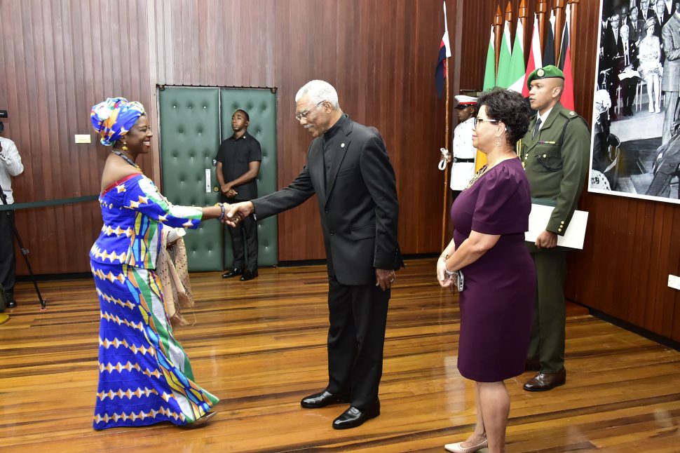 President David Granger (centre) greets newly accredited High Commissioner of Ghana to Guyana,  Abena Pokua Adompim Busia as Director General of the Ministry of Foreign Affairs, Audrey Waddell looks on. (Ministry of the Presidency photo)  
