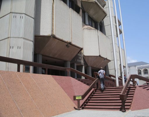 A member of the public makes his way into the Hall of Justice, yesterday.