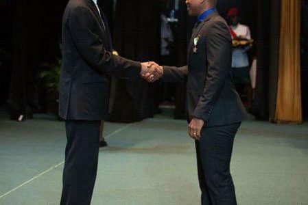 Test cricketer and Guyana Jaguars skipper Leon Johnson receives his National Award from His Excellency David Granger.