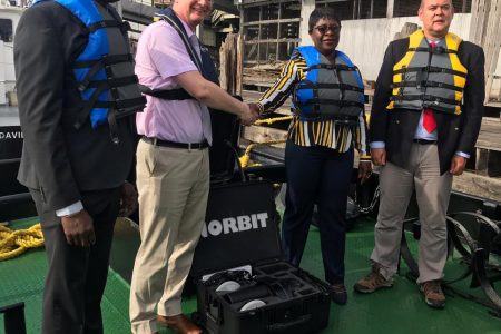 British High Commissioner Greg Quinn (second from left) hands over the Sonar Equipment to MARAD’s Director General, Claudette Rogers. They are flanked by Chief Executive Officer of the Guyana Lands and Surveys Commission, Trevor Benn (left) and Lead Trainer, Ian Davies (right).