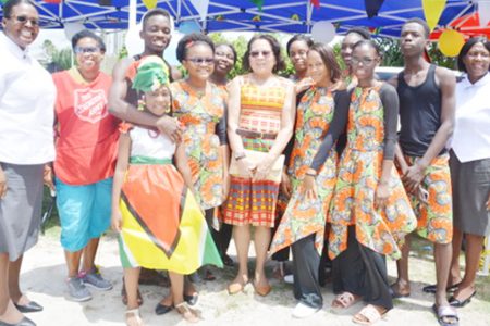 Photo shows First Lady Sandra Granger (centre) with some of the attendees at the funfair. (Ministry of the Presidency photo)