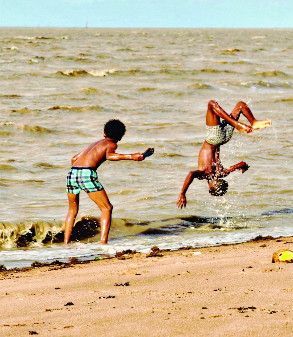 Two boys try out their gymnastics skills at Bushy Park Beach in Essequibo. (Photo by Joanna Dhanraj)