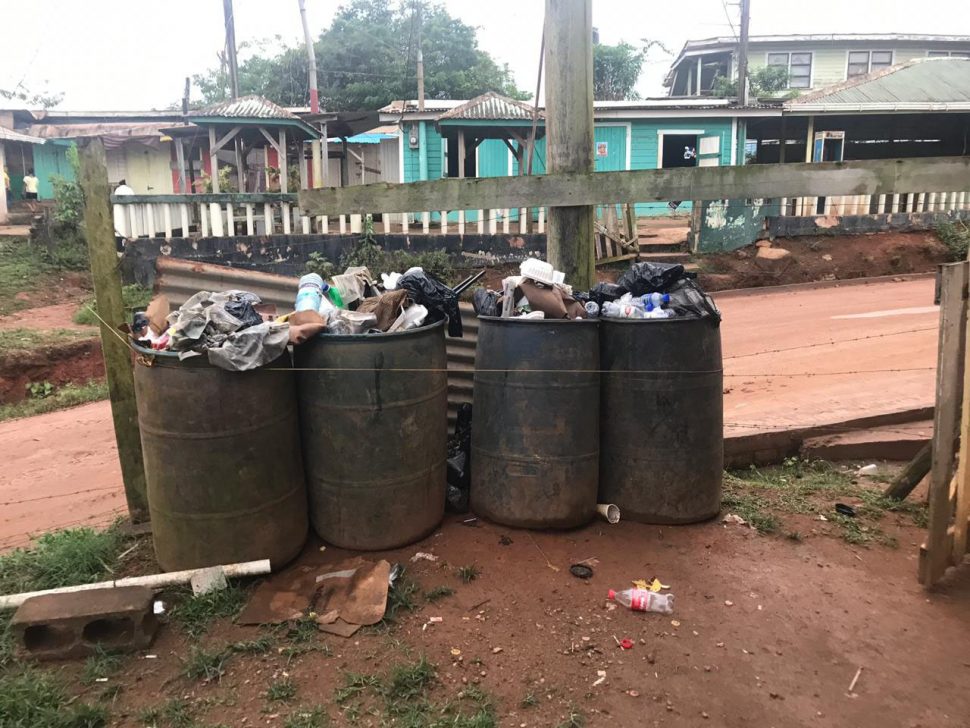 Barrels of garbage overflowing in the Port Kaituma Police Station compound 