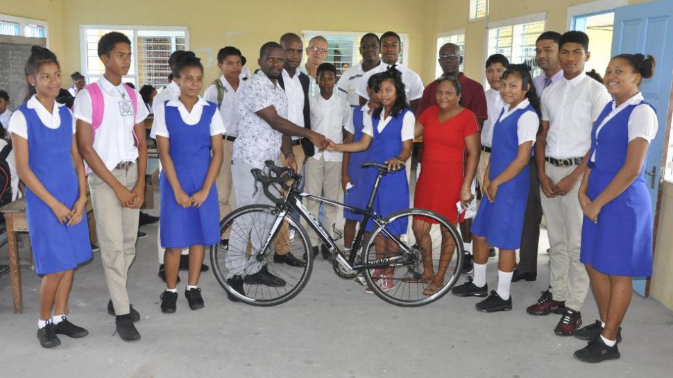 Selene Stephen being presented with the racing cycle by Horace Burrowes of the Guyana Cycling Federation. 