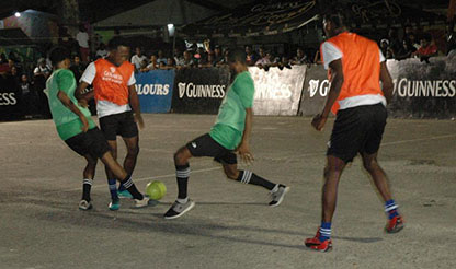 Marley Major [center] of Quiet Storm being challenged by two Capitol Storm players during their quarterfinal matchup in the Guinness ‘Greatest of the Streets’ Linden Championship at the Mackenzie Market Tarmac
