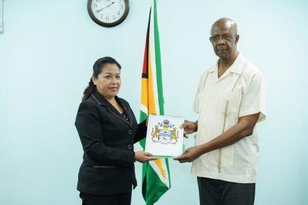Lance Carberry, who will be heading the Board of Inquiry, receiving his Instrument of Appointment from Minister of State Dawn Hastings-Williams. (Ministry of the Presidency photo)