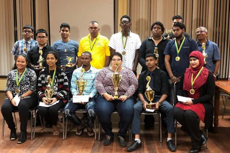 The awardees pose with their accolades following the Guyana Chess Federation’s Awards Ceremony Friday evening. 
