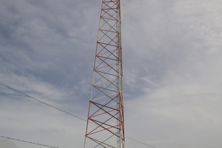 The former GuySuco transmission tower at Drill, now outfitted with two mircrowave relay dishes. (Photo by Terrence Thompson)