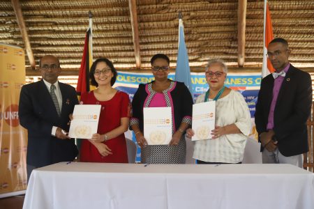 From left Indian High Commissioner to Guyana MR Venkatachalam Mahalingham; United Nations Resident Coordinator Mikiko Tanaka; Minister of Public Health Volda Lawrence; Representative and Director of the UNFPA Sub-regional Office for the Caribbean Alison Drayton; UNFPA Liaison officer for Guyana Adler Bynoe at the symbolic signing of the three year India-UN Development Partnership Fund (UNDPF) project. (Photo by Terrence Thompson)