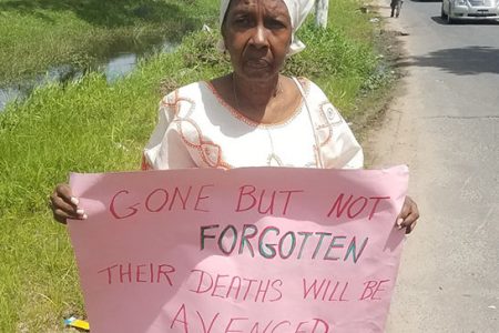 Sister Penda Guyan holding her placard on the protest line on Wednesday morning
